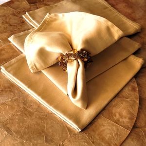 4 capiez shell chargers with 4 gold napkins and 4 brownstone  napkin rings